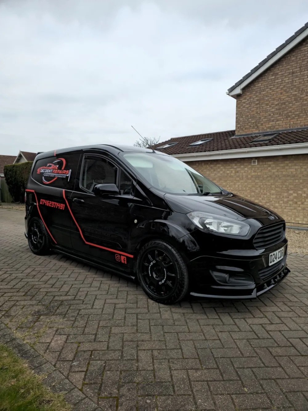 Derrick's black DC Dent Repairs mobile workshop van with red branding