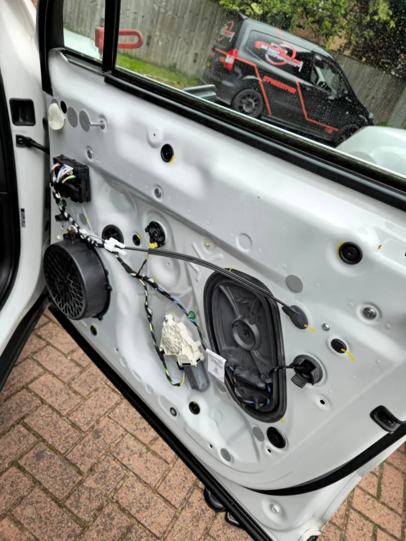 Porsche door with interior trim removed to gain access behind the dent